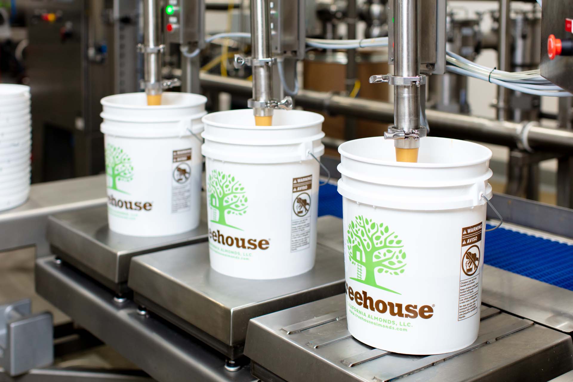 Almond Butter being poured into Treehouse pails during production