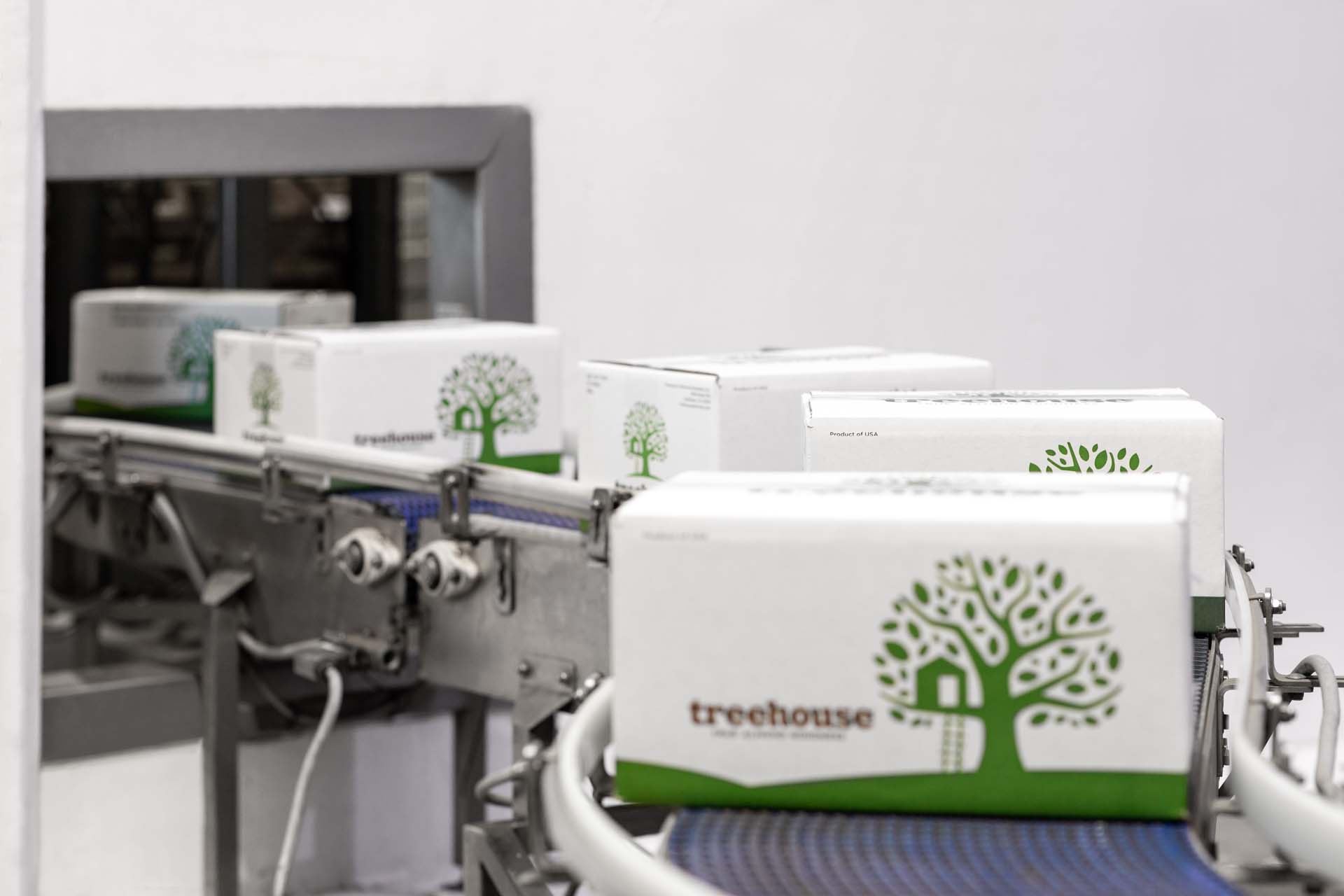 Boxes of Treehouse Almond Product on a Conveyor Belt - Storage for Organic Almond Products