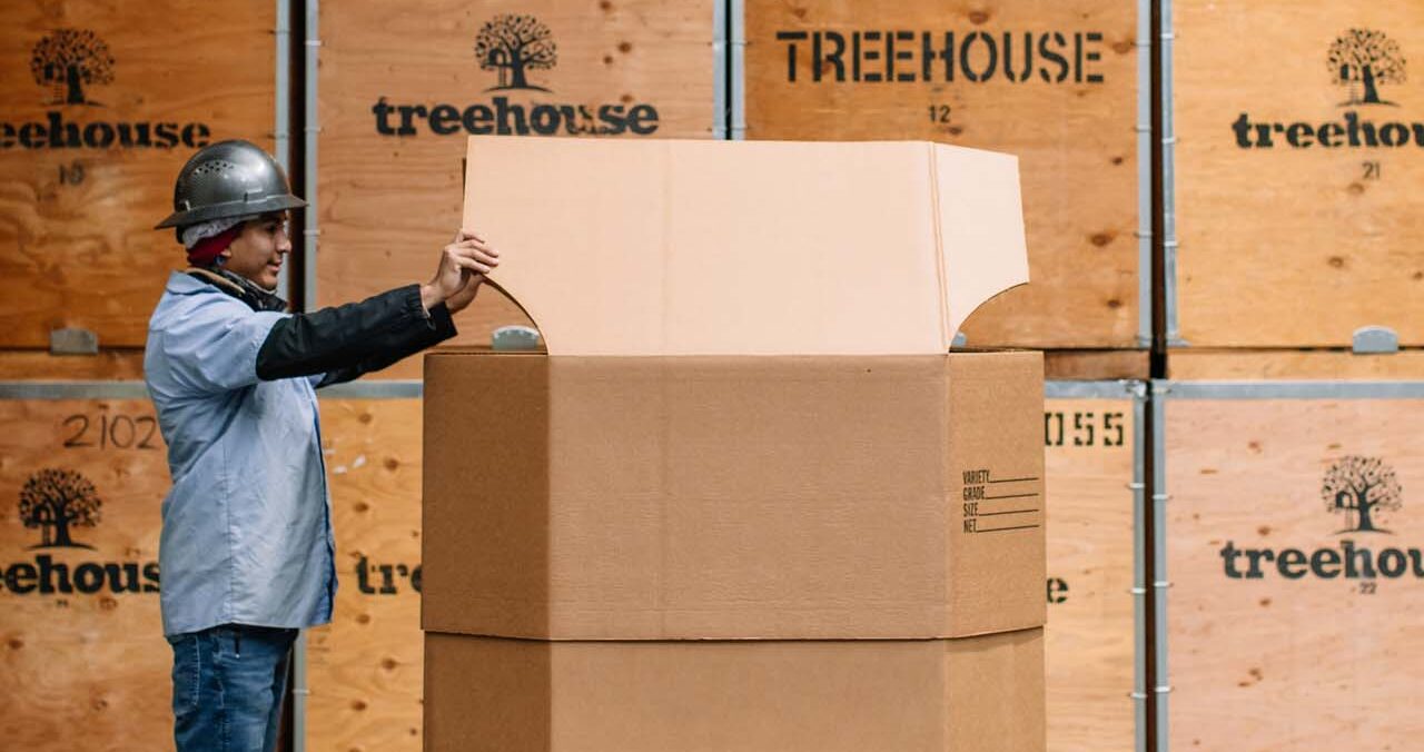 Treehouse employee opening up a fiber bin
