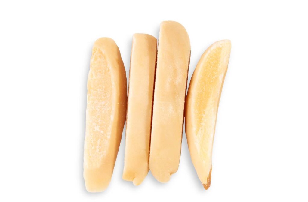 Closeup of four roasted slivered almonds