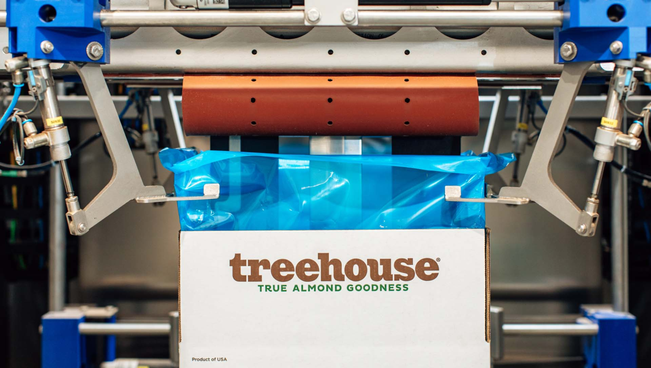 Almond boxes being filled by machines - Treehouse Leading Technology