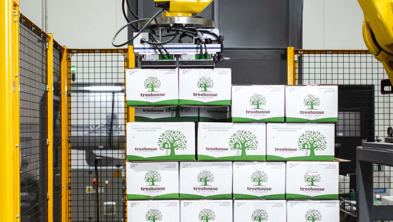 Almond boxes being stacked by machines - Treehouse Leading Technology