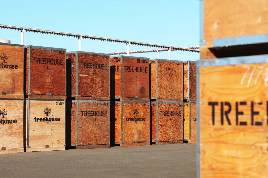 Bins of Treehouse almond products stacked outside in Earlimart, CA
