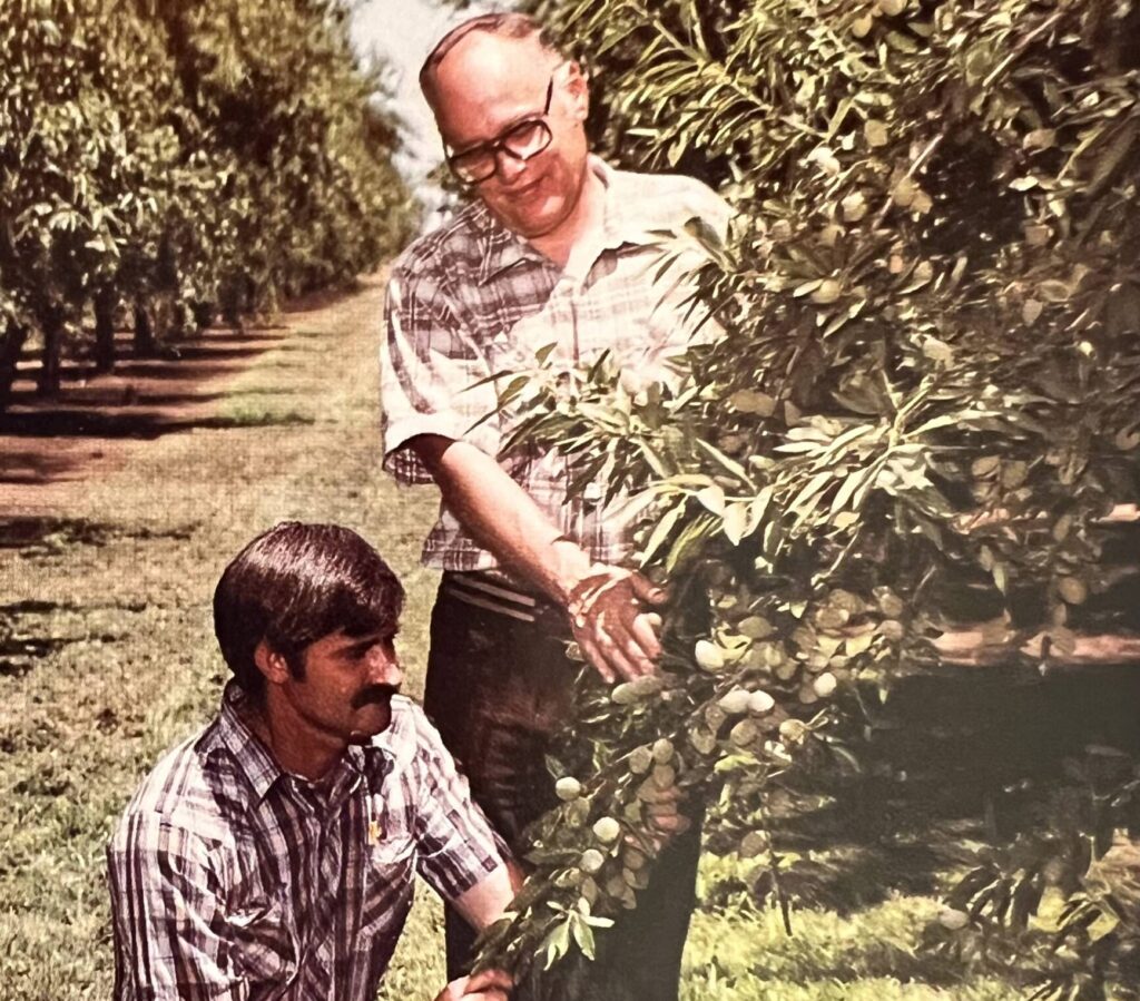 Dr. John Malley planting almond trees in California’s fertile Southern San Joaquin Valley