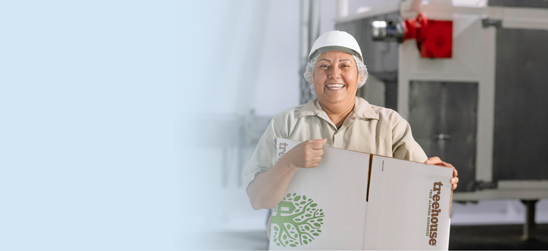 Treehouse Almond Worker holding a shipping box for almonds